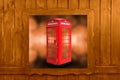 Classic British red phone booth in London UK, wooden window Royalty Free Stock Photo