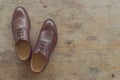 Classic brown leather mens shoes on wooden background Royalty Free Stock Photo