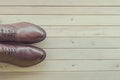 Classic brown leather mens shoes on wooden background Royalty Free Stock Photo