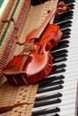 classic brown violin on the close up image of grand piano keys and interior background Royalty Free Stock Photo