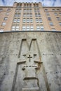 Classic Building Facade with Religious Emblem, Upward View