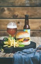 Classic burger dinner with beer and french fries Royalty Free Stock Photo