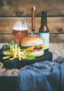 Classic burger dinner with beer and french fries, copy space Royalty Free Stock Photo