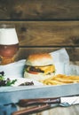Classic burger dinner with french fries, salad and beer Royalty Free Stock Photo
