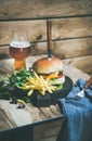 Classic burger dinner with glass of beer and french fries Royalty Free Stock Photo