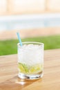 Classic caipirinha cocktail by a pool outdoors