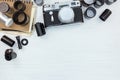 classic camera, negative films rolls and notebook on white wooden flat view