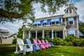 Classic Cape Cod house with sunchairs lined up Royalty Free Stock Photo