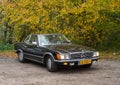 Classic car Mercedes Benz 280 SE convertible parked under autumn trees Royalty Free Stock Photo
