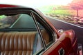 Classic  car. Red car. View of the rear seat in brown leather. Close up. High-end car. Collectable. Vehicle. Conveyance. Rea Royalty Free Stock Photo