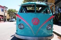 Monterey, CA, USA - 18 Aug 2022: Close up of the front of an eye-catching bright blue and pink VW mini bus.