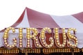 Circus sign with circus lettering against a red and white striped circus tent