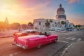Classic cars in Havana near the Capitol at sunset