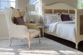 Classic chair with brown pillow on carpet in vintage style bedroom