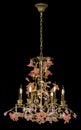 Classic chandelier in flower style isolated on black background.