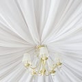Classic chandelier hanging on ceiling made of white cloth