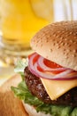 Classic cheeseburger with beer on background Royalty Free Stock Photo