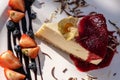 Classic cheesecake with raspberry jam on a plate decorated with fresh strawberries Royalty Free Stock Photo