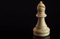 Classic Chess White Bishop on black surface, isolated Royalty Free Stock Photo