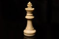 Classic Chess White King on black board, isolated Royalty Free Stock Photo