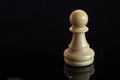 Classic Chess White Pawn on black surface, isolated Royalty Free Stock Photo