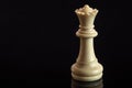 Classic Chess White Queen on black surface, isolated Royalty Free Stock Photo