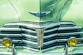 Close-up of a classic Green Chevrolet front with Chrome Grill