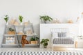A classic child bedroom interior with simple, scandinavian style furniture and a gray wooden bookcase with a teddy bear Royalty Free Stock Photo