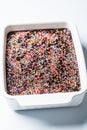 Classic chocolate cake with colored sprinkles in baking dish