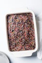 Classic chocolate cake with colored sprinkles in baking dish