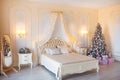 Classic Christmas decorated interior room with New year tree. Modern luxury design apartment bedroom with bed. Christmas Royalty Free Stock Photo