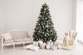 Classic christmas New Year decorated interior room New year tree. Christmas tree with gold decorations. Modern white classical sty Royalty Free Stock Photo