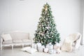 Classic christmas New Year decorated interior room New year tree. Christmas tree with gold decorations. Modern white classical sty