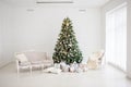 Classic christmas New Year decorated interior room New year tree. Christmas tree with gold decorations. Modern white classical sty Royalty Free Stock Photo