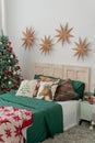Classic Christmas tree decorations. Golden stars on the wall in the bright sunny room Royalty Free Stock Photo