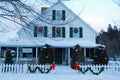 Classic Christmas wreaths and holly on a New England home