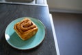 classic cinnamon roll on an artisan plate in the kitchen top view Royalty Free Stock Photo