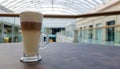 Classic coffee latte macchiato in a glass cup on the table. Glass cup with hot drink Royalty Free Stock Photo