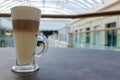 Classic coffee latte macchiato in a glass cup on the table. Glass cup with hot drink Royalty Free Stock Photo