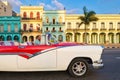 Classic convertible car and old colorful buildings in downtown Havana