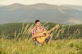 Classic Cool. acoustic guitar player. country music song. sexy man with guitar in checkered shirt. hipster fashion Royalty Free Stock Photo