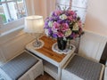 Classic Corner Interior with Lamp and Vase of Colorful Flowers