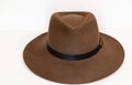 Classic cowboy brown felt hat with strap and copper closure on white background Royalty Free Stock Photo