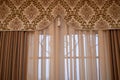 Classic curtains with tapestry insert and brush.A classic window with heavy curtains.