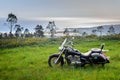 classic custom black motorcycle on the background of a beautiful landscape with the ocean