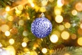 Classic decorated Christmas tree with ornaments ball colored in trendy color of year 2022 Very Peri background. Inspired