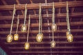 Classic different retro light bulbs hanging on brick wall background at night . wooden ceiling . cable . Beautiful retro luxury