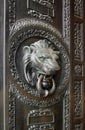 A classic door knocker in the shape of a lion.