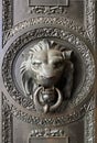 A classic door knocker in the shape of a lion.