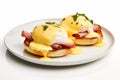 Classic eggs benedict with ham and hollandaise sauce isolate on white background